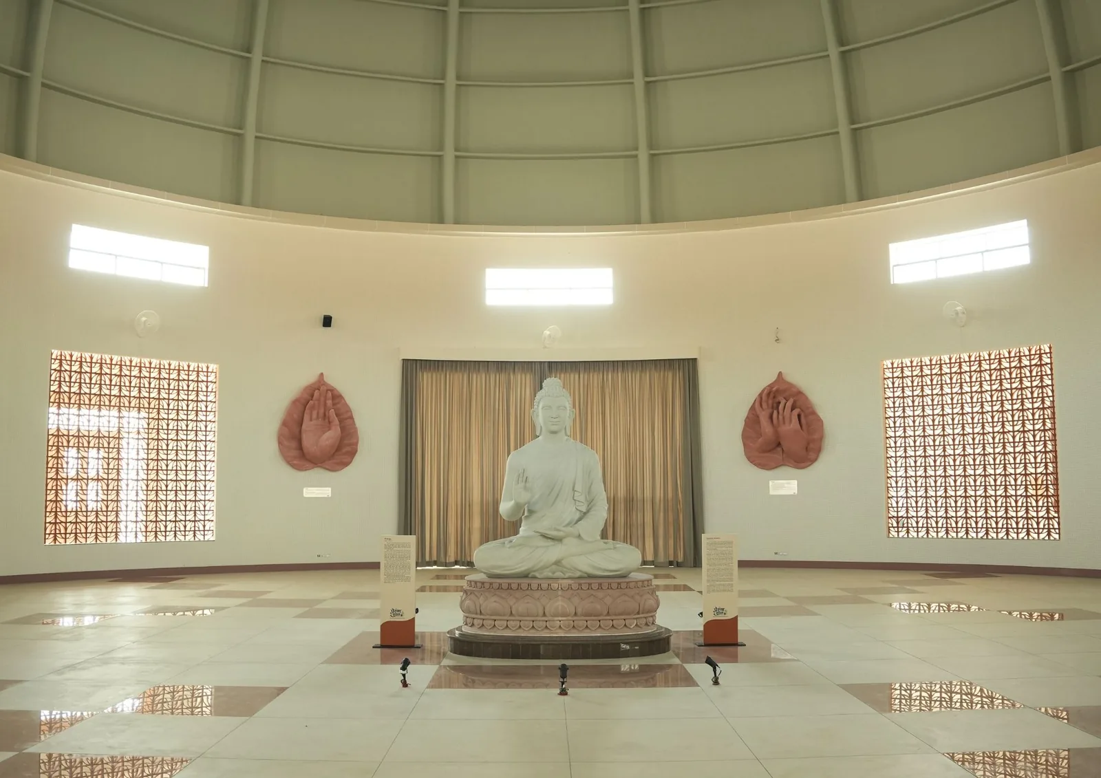 The meditation hall under the dome, with the Buddha statue at its centre